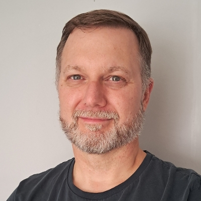 Headshot image of Oz Harbottle smiling.